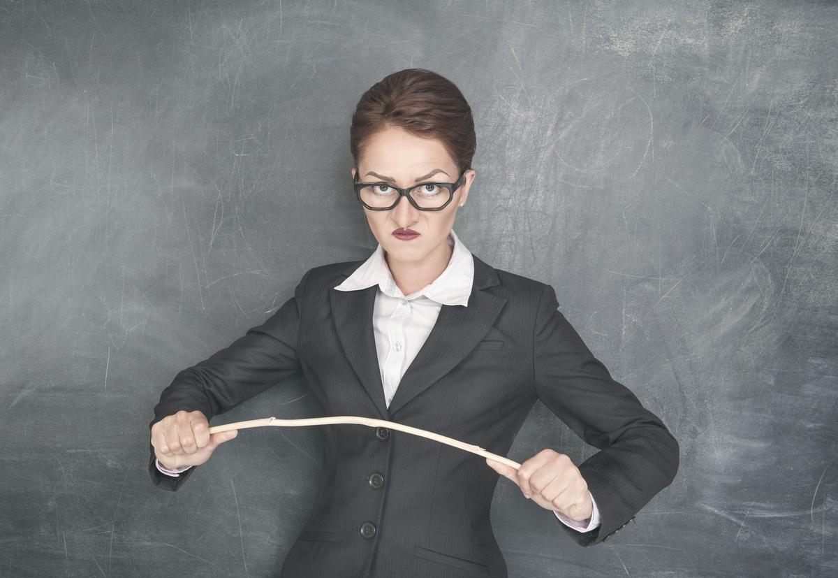 Angry teacher with wooden stick.