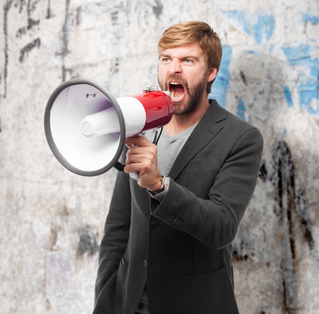 angry-businessman-making-an-announcement-with-bullhorn_1154-251